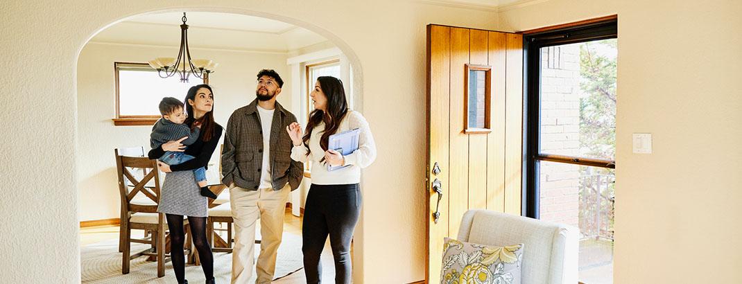 Family touring potential home with real estate agent