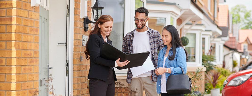 couple looking at folio with their agent