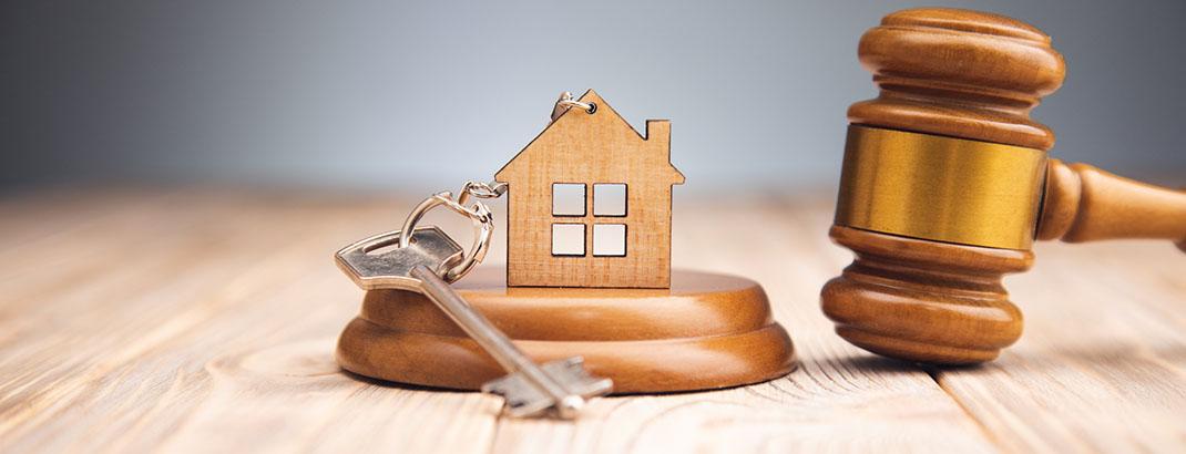 keychain with house key on sound block next to gavel